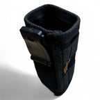 Schwarze strukturierte stoff-handytasche mit schwarzem kunststoffclip auf der rückseite von maykker smart bag smarttube