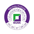Munk prüfplakette mit lila und grüner kreisförmiger prüfmarke und segmentiertem zifferblatt zur datumswahl